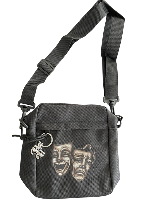 Black shoulder bag with theatrical masks. Old school Chicano art style